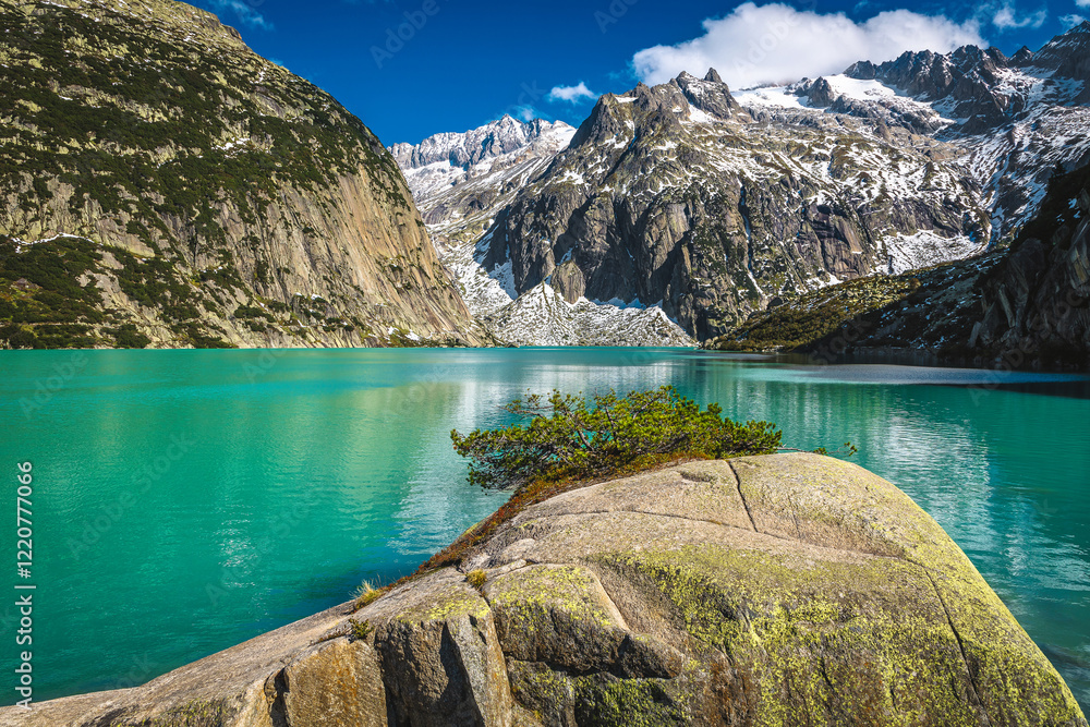 Turquoise Gelmersee lake and snowy mountains, Grimsel Pass, Switzerland
