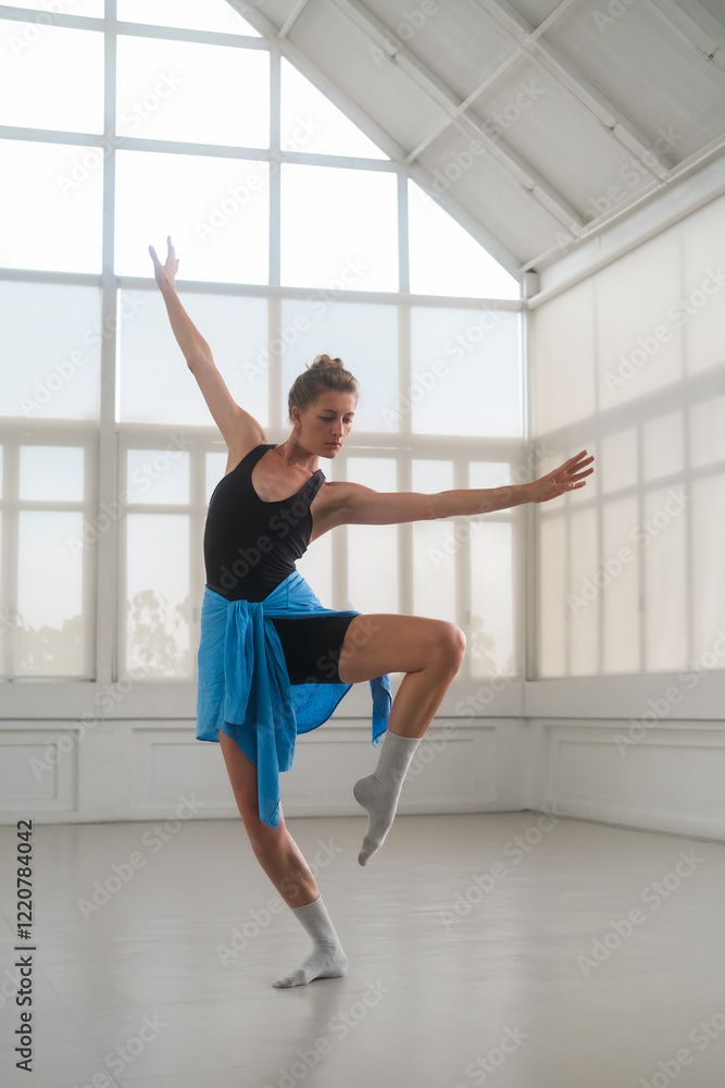 A ballerina rehearses in a bright, minimalist studio with large windows. Her elegant pose highlights ballet, grace, and poise, capturing the art and dedication of professional dance practice. A ballerina rehearses in a bright, minimalist studio with large windows. Her elegant pose highlights ballet, grace, and poise, capturing the art and dedication of professional dance practice.