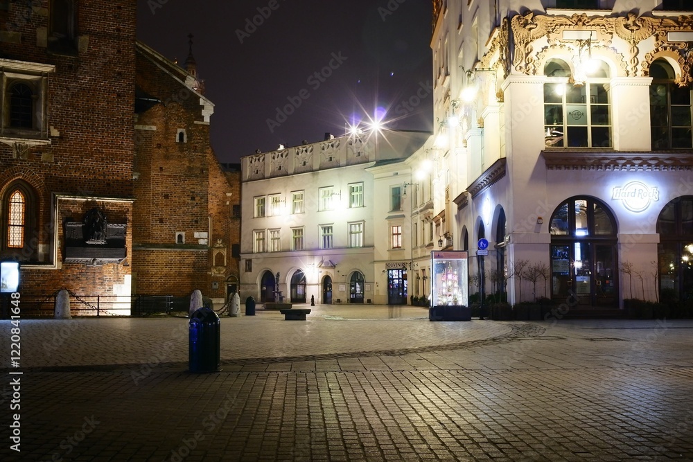 Obraz premium A lively city square at night with bright buildings and lights