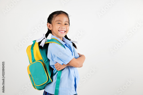 Portrait smiling Asian little girl kindergarten with schoolbag crossed arms studio shot isolated white background, good job feedback, happy woman kid in pigtails wearing school uniform, back to school photo