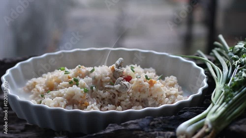 Hot Fried rice with pork and egg in a white plate on a wooden background