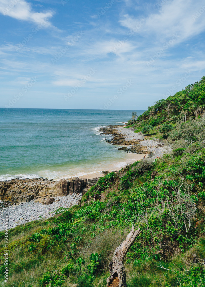Fototapeta premium Sunny portrait of Granite bay and winch cover towards fairy pools at Noosa National park, Noosa, QLD Australia