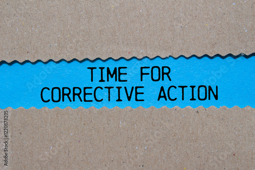 Photos Time for corrective action message written on ripped torn paper on blue background