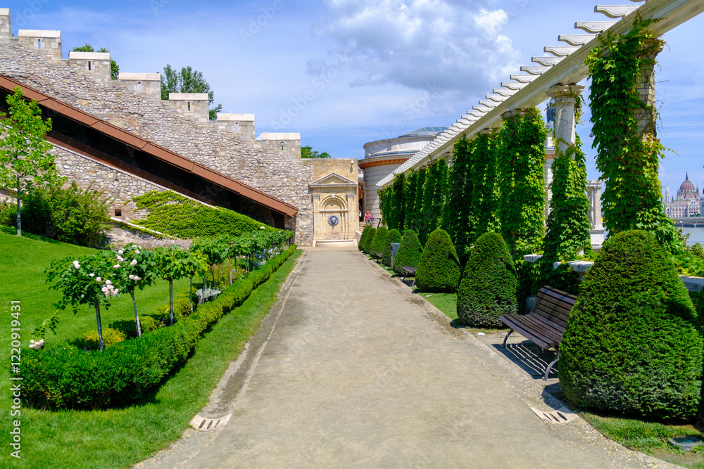 A scenic path in a beautiful park with a stone wall backdrop A scenic path in a beautiful park with a stone wall backdrop