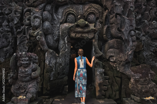 Female Tourist Entering Goa Gajah Elephant Cave in Bali, Indonesia.