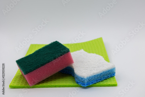 Colorful sponges and cleaning cloth on grey backround.