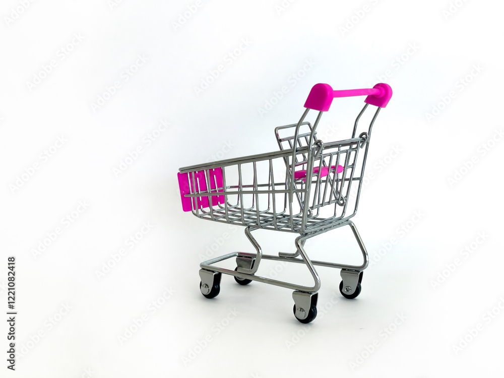 Miniature Shopping Cart With Pink Handles On White Background, Studio Setting, Perfect For Marketing Concepts, Retail Promotions, E-Commerce, Business Advertising, Consumer Awareness, And Sales Campai Miniature Shopping Cart With Pink Handles On White Background, Studio Setting, Perfect For Marketing Concepts, Retail Promotions, E-Commerce, Business Advertising, Consumer Awareness, And Sales Campai