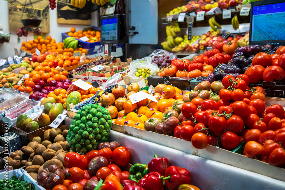 Obraz premium Fruit and fresh vegetable stall at a food market. Big variety of farm products