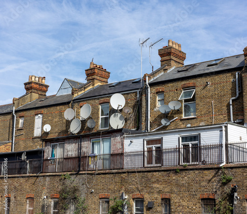  Row of houses with loads of satellite dishes attached
