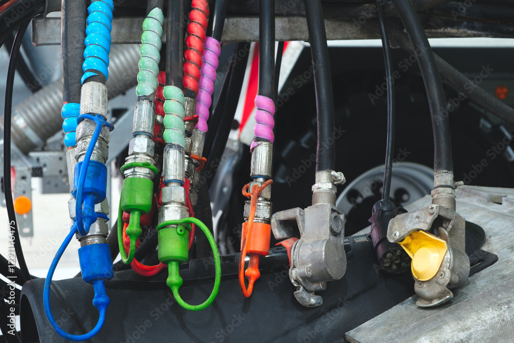 A bunch of colorful rubber hose clamps are hanging from a vehicle. The clamps are in various colors, including green, red, blue, and yellow. Concept of organization and attention to detail A bunch of colorful rubber hose clamps are hanging from a vehicle. The clamps are in various colors, including green, red, blue, and yellow. Concept of organization and attention to detail