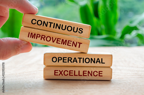 Continuous improvement and operational excellence text on wooden blocks. Business strategy and improvement concept