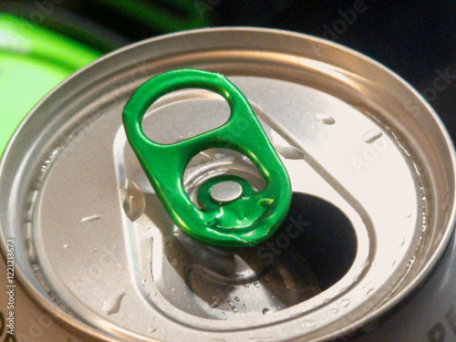 Close-up of a green soda can tab on its surface, highlighting freshness and modern design. Perfect for beverage-related projects and product designs. photo