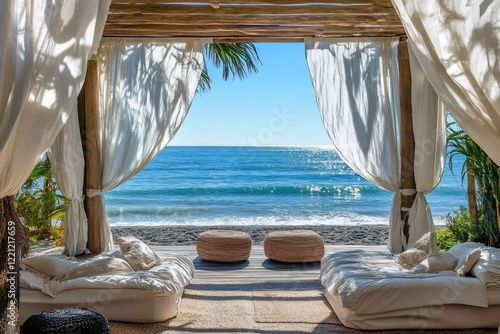 White-curtained beach cabana facing vibrant blue sea  providing tranquil tropical retreat with pristine horizon and serene atmosphere