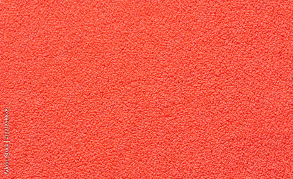 Fototapeta premium Bright red textured carpet close up with soft fiber pattern and detailed abstract design.