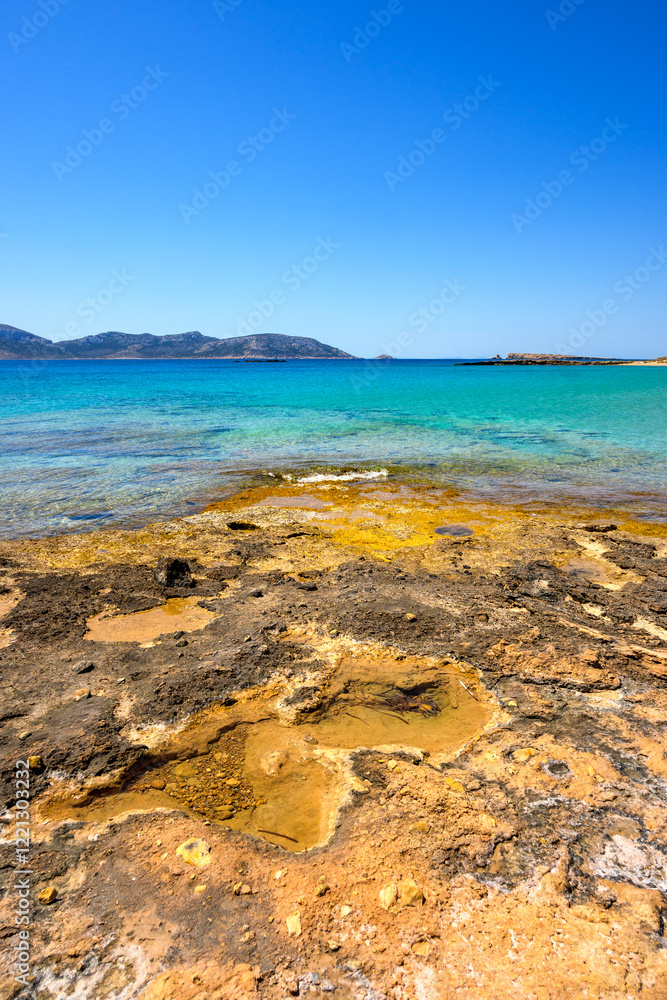 Ano Koufonisi beach with rocks and azure sea water. Small Cyclades, Greece