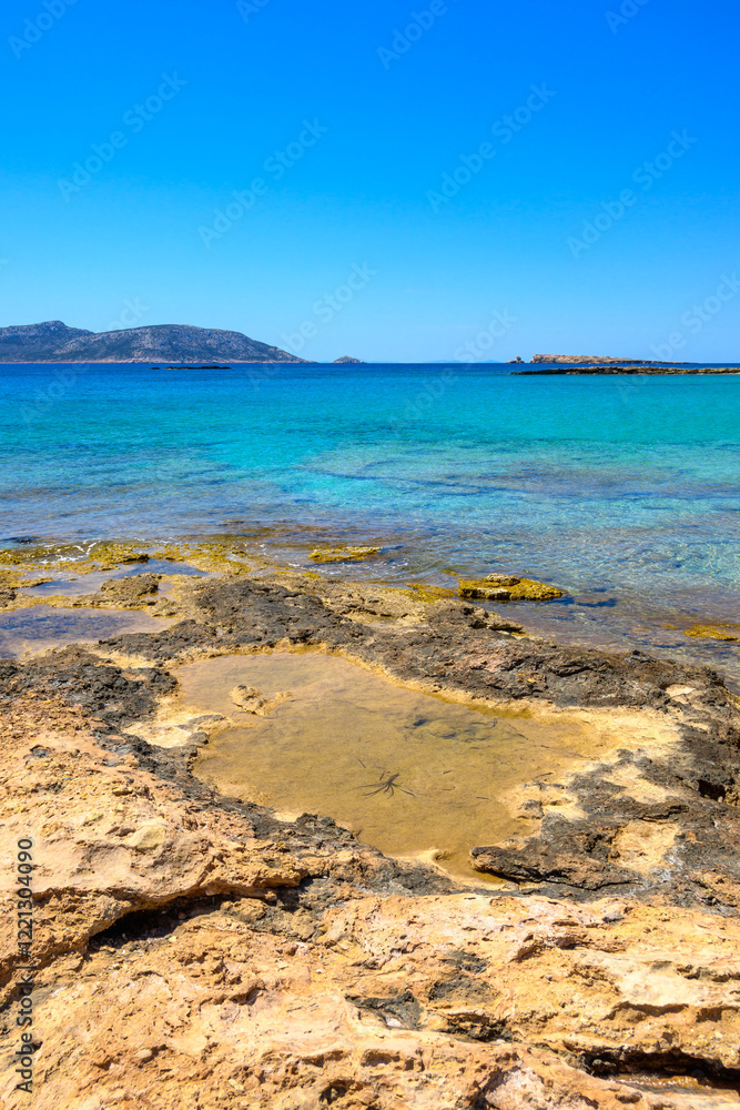 Ano Koufonisi beach with rocks and azure sea water. Small Cyclades, Greece