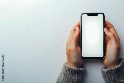 Close-Up View of Hands and a Mobile Phone Featuring a Plain White Screen Display
 photo