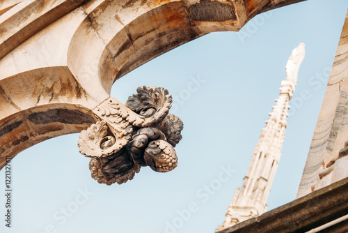 Intricate details of Duomo di Milano featuring gothic arches, statues, spires and ornate carvings. Stunning craftsmanship highlights rich history, artistic elegance of iconic architectural masterpiece photo