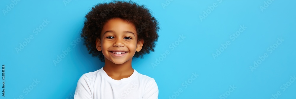 Smiling young boy with curly hair against bright blue background, showcasing joy and innocence, perfect for children's themes and portraits Smiling young boy with curly hair against bright blue background, showcasing joy and innocence, perfect for children's themes and portraits