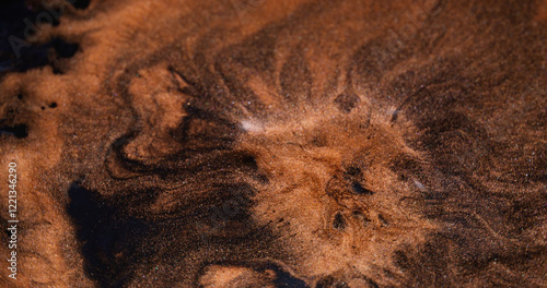 Art magma. Shimmering explosion. Orange paint lava eruption volcano. Molten copper mass spread mix across black liquid abstract background.