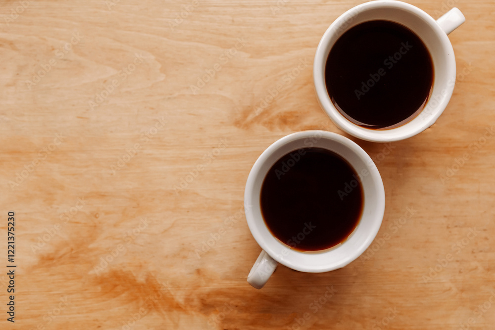 Two coffee cups on wooden background, top view, copy space Two coffee cups on wooden background, top view, copy space