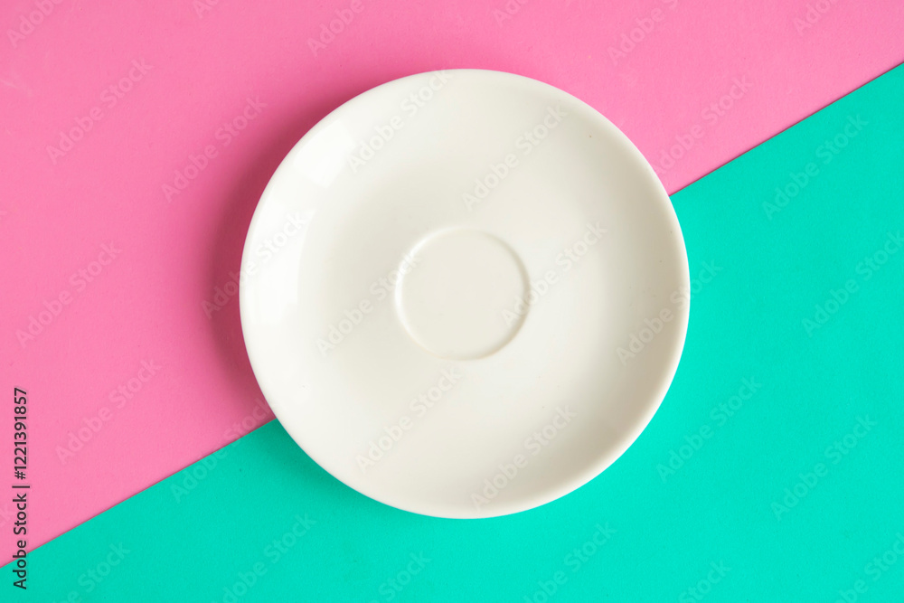 Empty plate on green and pink background. Copy space for the text. Minimal concept Empty plate on green and pink background. Copy space for the text. Minimal concept