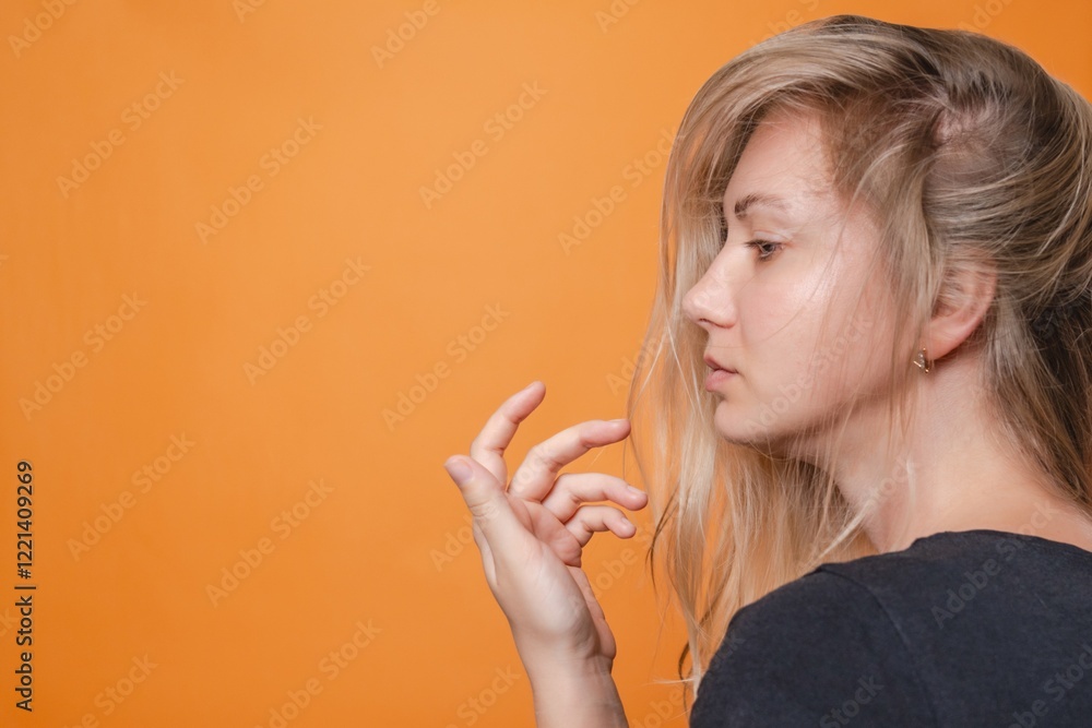 Elegant woman portrait. Attractive sensual young blond woman. Orange background. Nude or no makeup Elegant woman portrait. Attractive sensual young blond woman. Orange background. Nude or no makeup