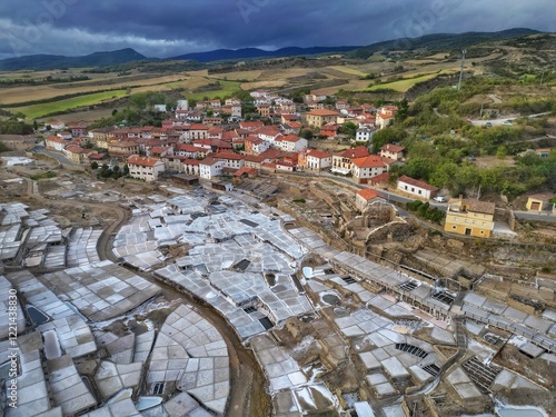 Aerial drone view of Anana Valley and its terraces for salt production, the oldest active salt mines in the world, in Alava, Basque Country, Spain, on a stormy day