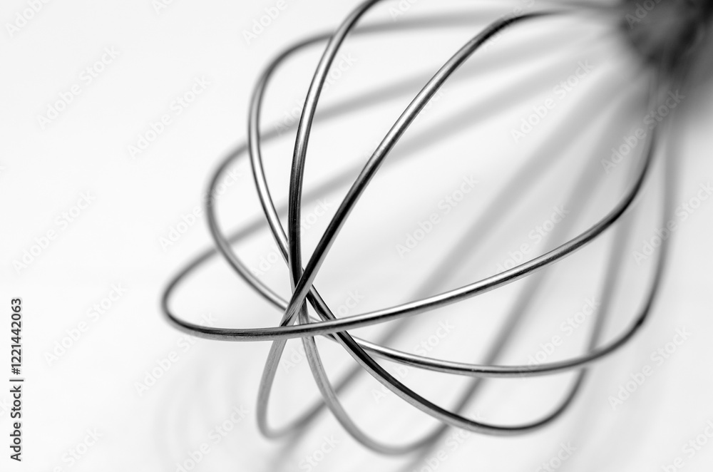 Minimalistic abstract of a wire whisk on a white background Minimalistic abstract of a wire whisk on a white background