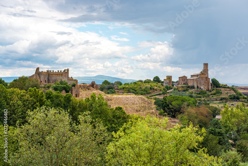 Lavello Tower and ruins of ancient castle are standing out in the skyline of Tuscania, a charming medieval town in the Lazio region of Italy, surrounded by lush vegetation and rolling hills