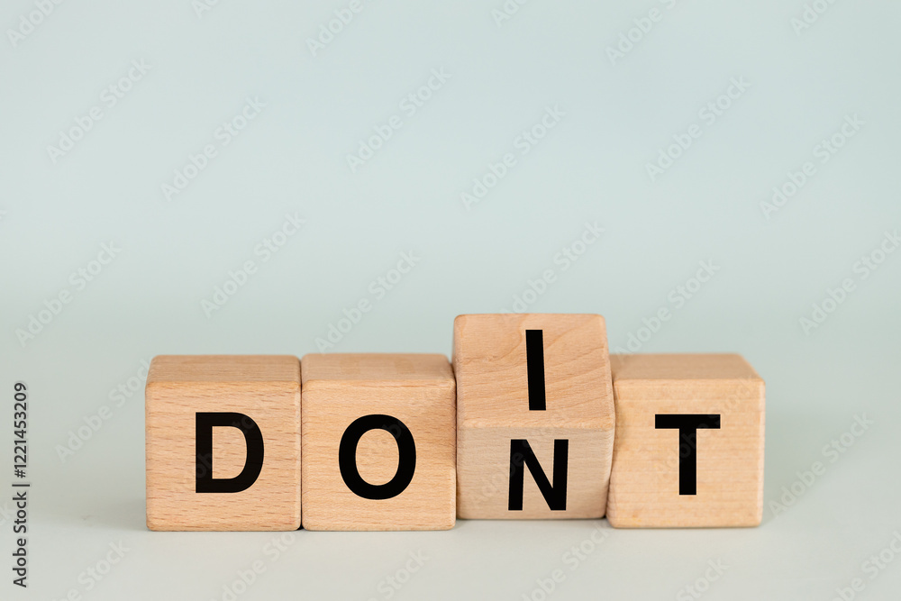 Don't do and do it. Conceptual words, don't do changing do it. Words on wooden blocks. copy space.