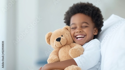 Wallpaper Mural An African American boy around five years old is laughing joyfully while hugging a teddy bear closely on his hospital bed. The soft focus in the background emphasizes his cheerful expression Torontodigital.ca