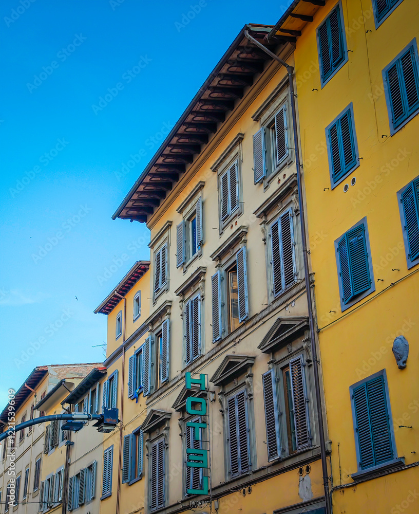 Fototapeta premium Old traditional Italian boutique hotel in Florence, Italy. Sign hotel on the typical building with wooden shutters