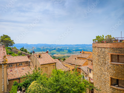 Volterra, Tuscany. Street view of Volterra - medieval Tuscan town located on a hill with old town, old houses, and towers in Italy photo