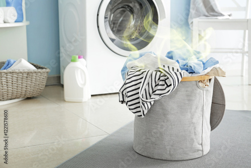 Basket with dirty laundry on floor in bathroom