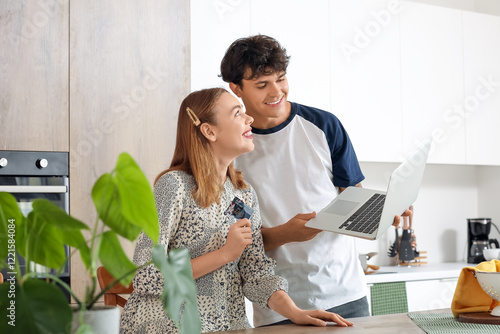 Young couple with laptop an...