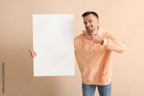 Happy young man pointing at...