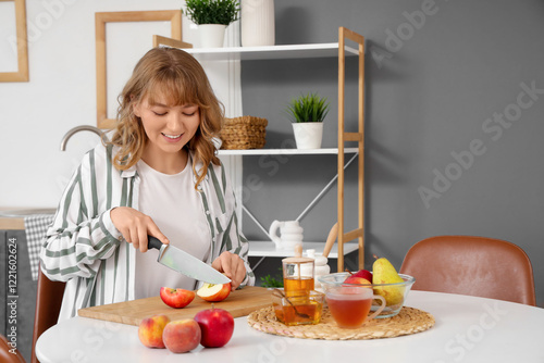 Woman cutting apples at tab...