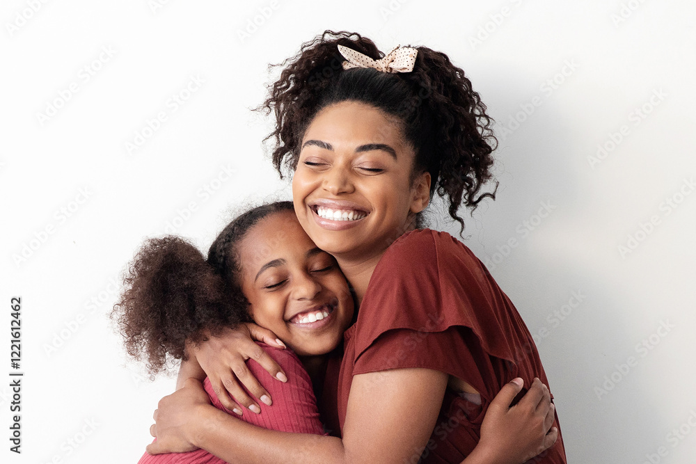 Parent and kid affectionate concept. Emotional african american mother hugging her beautiful daughter teenager, bonding on floor by white empty wall, panorama with copy space for advertisement Parent and kid affectionate concept. Emotional african american mother hugging her beautiful daughter teenager, bonding on floor by white empty wall, panorama with copy space for advertisement