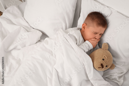 Sick little boy in bed