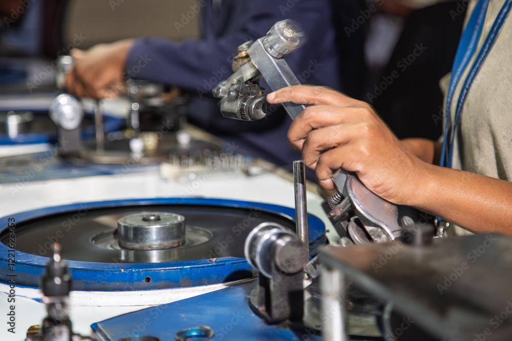 Polishing wheel in a diamond factory in Botswana, showcasing an African worker's hands polishing a rough diamond facet on a spinning wheel, representing precision and craftsmanship, diamond industry Polishing wheel in a diamond factory in Botswana, showcasing an African worker's hands polishing a rough diamond facet on a spinning wheel, representing precision and craftsmanship, diamond industry