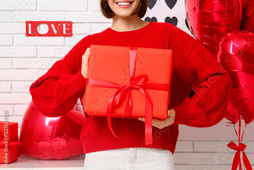 Young woman with gift box a...