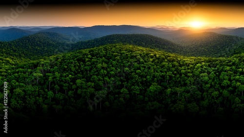 Sunset over lush green mountain range, aerial view