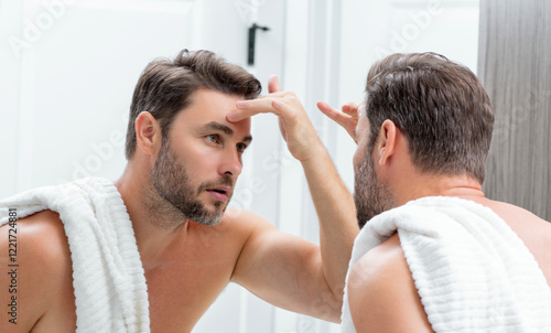 Mens beauty. Cream treatment for mens face. Beauty routine. Face of a beauty man with perfect skin. Anti-aging and wrinkle cream. Concept of male beauty. Male skincare cosmetics concept. Skin care.