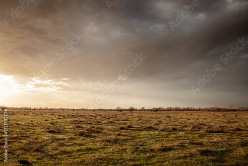 A quiet pasture at dusk reveals calm fields and soft hues, reflecting a region’s agricultural roots and serene countryside ambiance under subtle evening light. photo