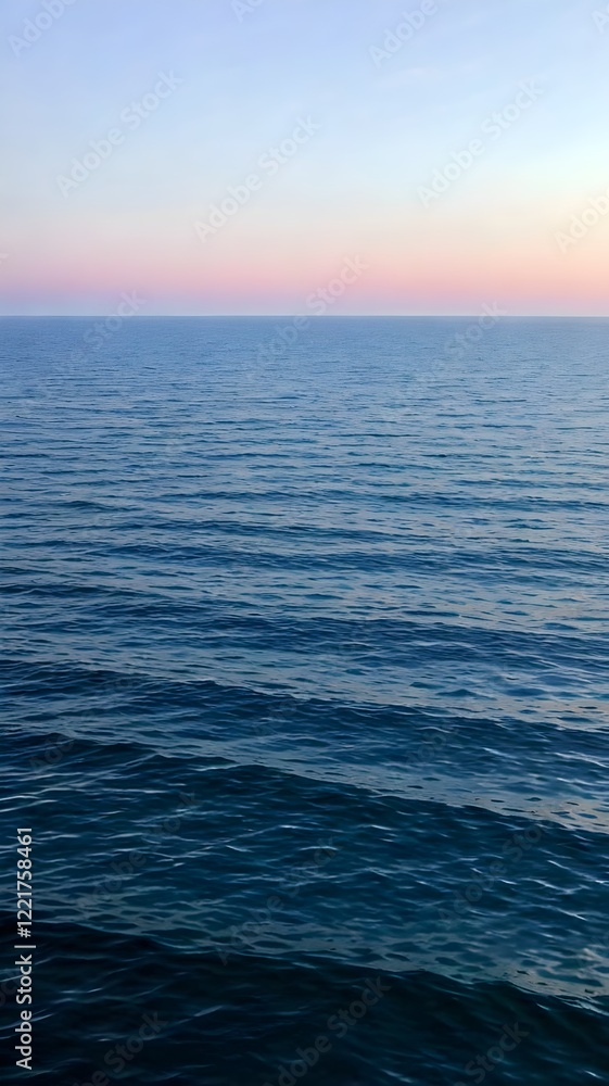 Fototapeta premium Serene ocean view with gentle waves and pastel horizon at dusk perfect for mobile wallpaper. Generative AI