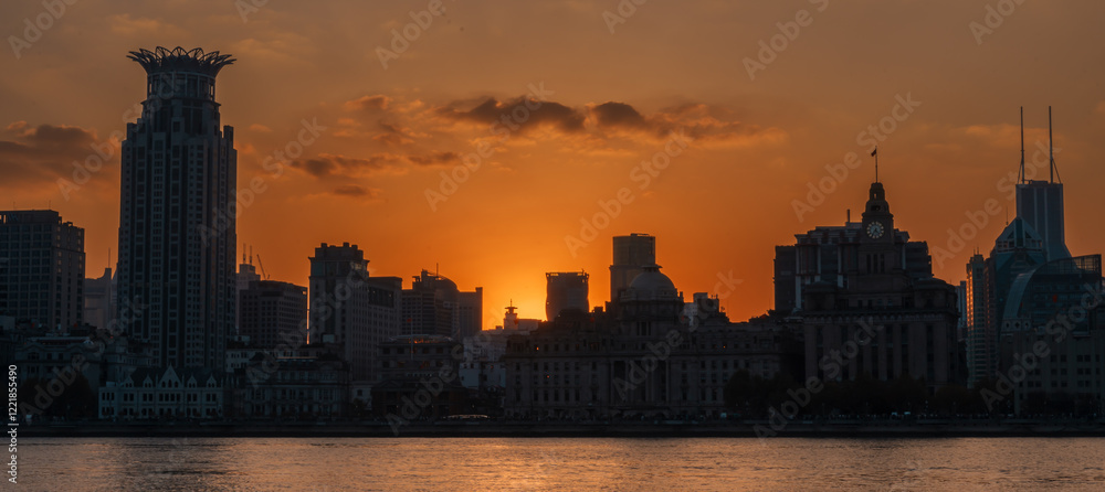 Fototapeta premium Cityscape view of Shanghai city at sunset. Skyscraper of the Bund, view from Lujiazui in Pudong of Shanghai, China. landmark and popular for tourism attractions. Travel and Vacation concept