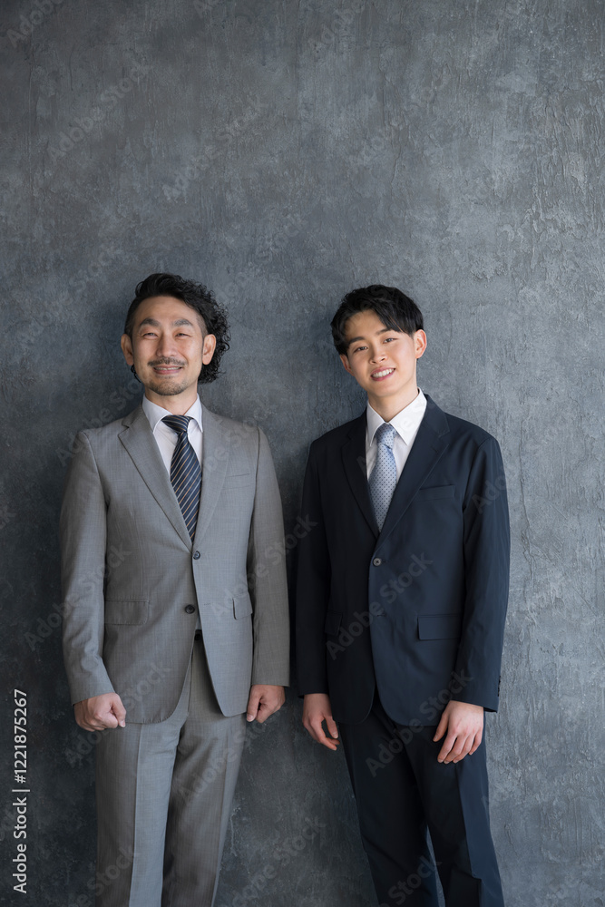 Businessmen standing side by side, looking at the camera and smiling Businessmen standing side by side, looking at the camera and smiling