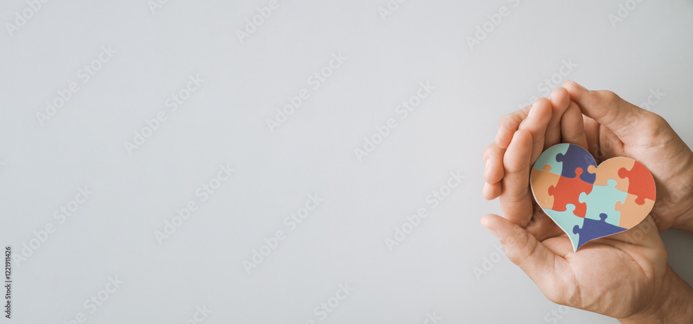 hands holding jigsaw puzzle heart shape, Autism awareness,Autism spectrum disorder family support concept, World Autism Awareness Day hands holding jigsaw puzzle heart shape, Autism awareness,Autism spectrum disorder family support concept, World Autism Awareness Day