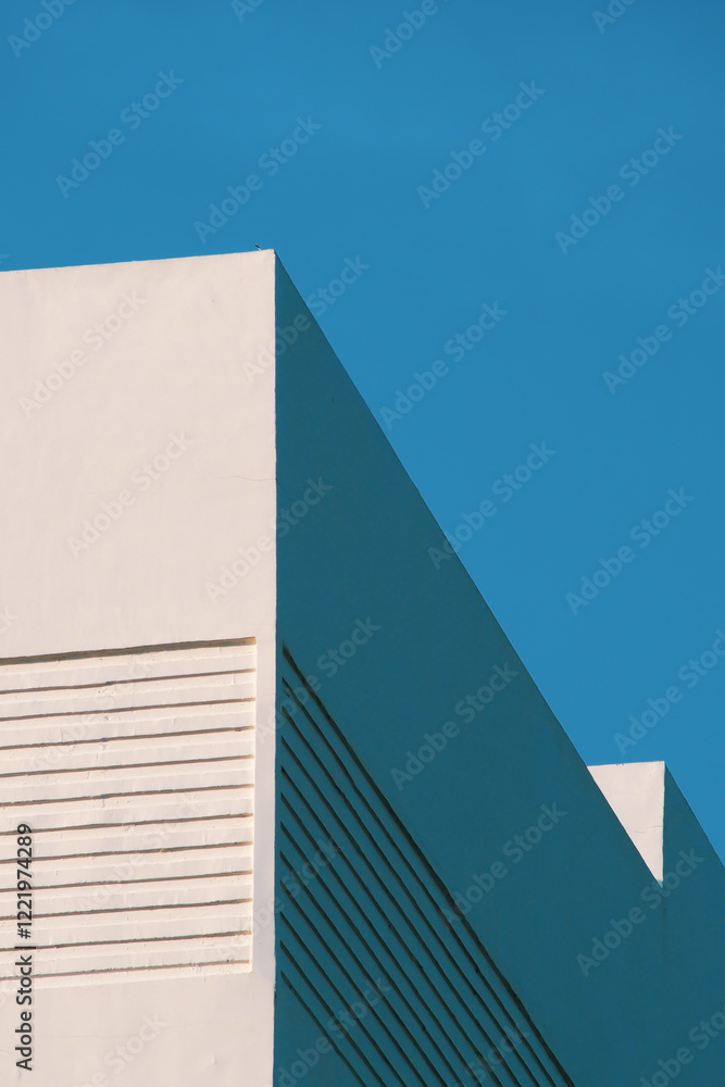 a minimalist white building facade against a vibrant blue sky, highlighting clean lines and geometric design elements. a minimalist white building facade against a vibrant blue sky, highlighting clean lines and geometric design elements.